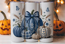 Load image into Gallery viewer, Three tall white insulated tumblers with autumn-themed pumpkin and wheat illustrations, displayed in front of Halloween pumpkins with warm string lights in the background.
