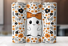 Load image into Gallery viewer, Three tall insulated tumblers with a white base and an all-over floral pattern in orange, black, and gray, with a cute smiling ghost wearing an orange bow centered on the middle tumbler. The tumblers are shown standing upright on a light surface with a softly blurred indoor background.
